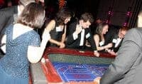 Employees at craps table of corporate sponsored casino theme party