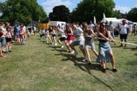teams playing tug of war for team building activity