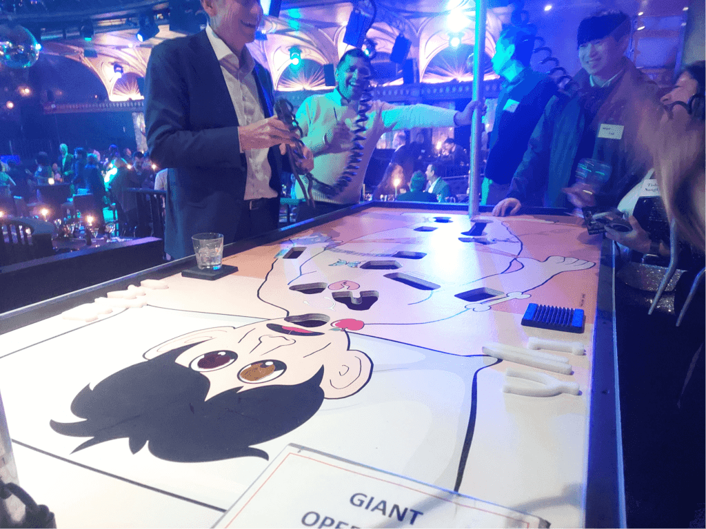 Guests playing Giant Operation Game rental at corporate gala event in New York City