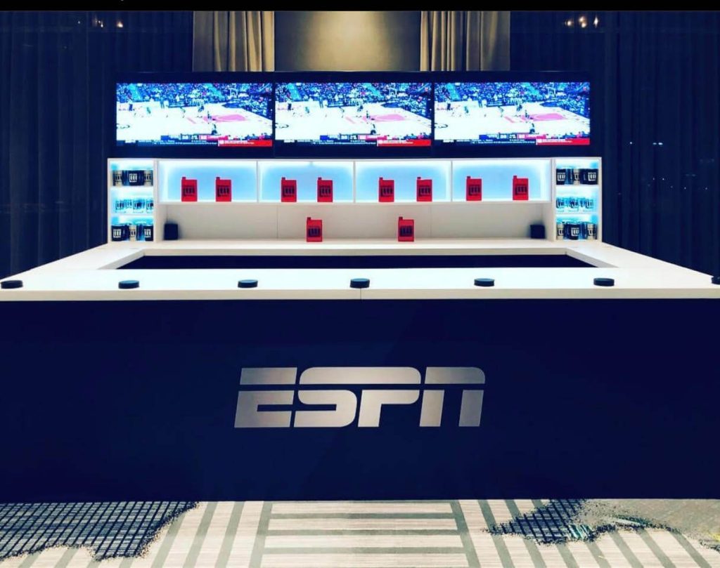 ESPN branded sports bar activation with multi-screen display wall and custom counter fabrication for corporate event NYC